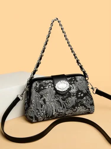 Elegant women's handbag in a single color with a metal chain handle