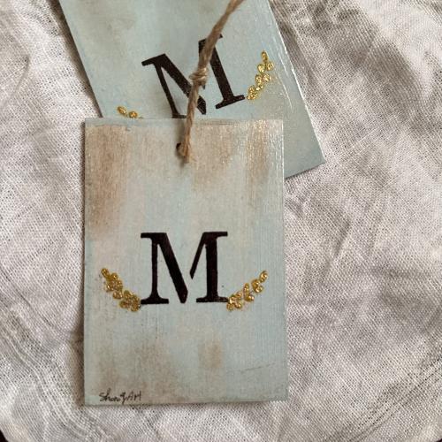 Golden wooden pendant with the letter M