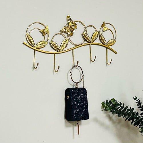 علاقة ملابس وعبايات حديد ذهبي بشكل دوائر وفراشات ب...