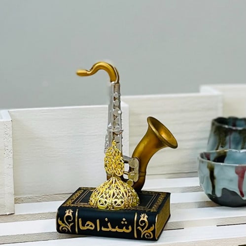 مبخرة سيراميك بشكل كتاب اسود انتيك وذهبي عليه ساكس...