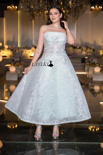 A white embroidered dress with a luxurious short design