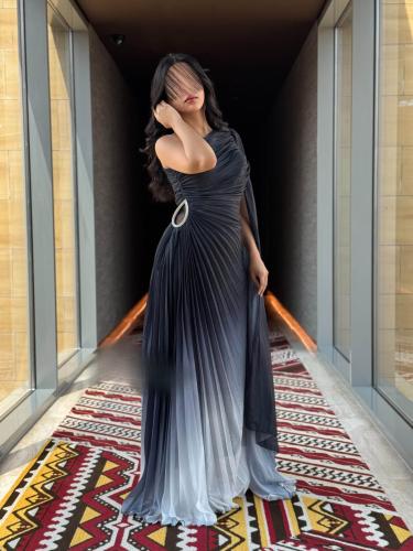A graduated dress in black and gray with luxurious pleats