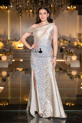 A gold dress embroidered with luxurious silver details
