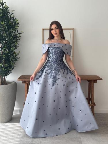 A snow gray dress with luxurious blue embroidery a...