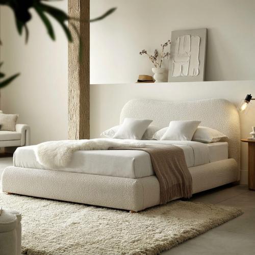 Heeba bed with luxurious upholstery with a curved and flowing design