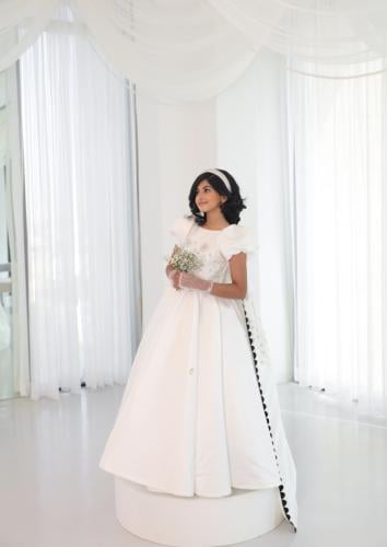 White dress with a back train decorated with sequins and luxurious embroidery