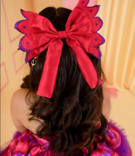 Red bow with the designer Maram Saeed logo