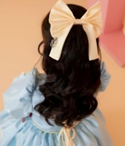 Yellow bow with the designer logo
