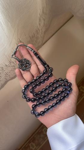 A tasbih with a turquoise shell, silver, transpare...