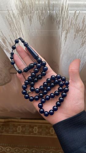A blue chameleon-colored prayer bead rosary