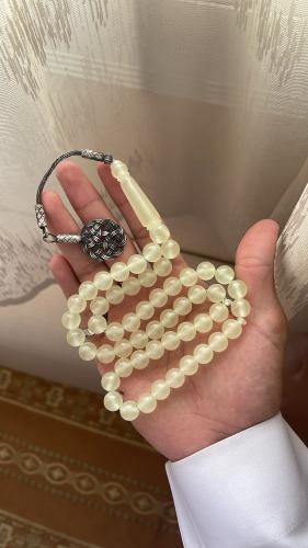 A tasbih with a claid Turquoise silver color (glowing in the dark)