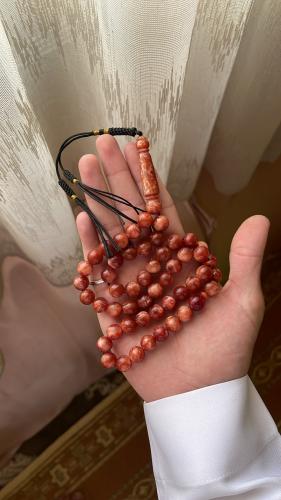 A light brown color prayer bead with a Korkosha Ku...