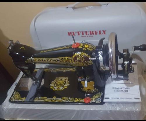 Hand sewing machine with butterfly