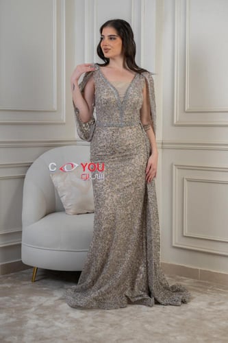 فستان سهرة مطرز فاخر بلون الشامبين بقصة أنيقة وذيل...