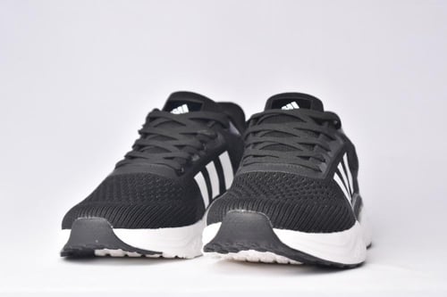 اديداس بوست اسود ابيض a black Adidas running shoe...
