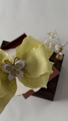 توكات شرايط أصفر مزينة بفراشة اكرلك