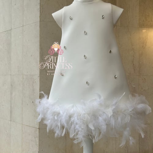 White dress decorated with feathers and crystals ف...