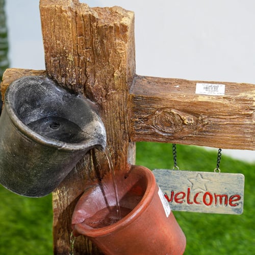 نافورة مياه علي شكل لوح خشبي مثبت عليها اباريق مقا...