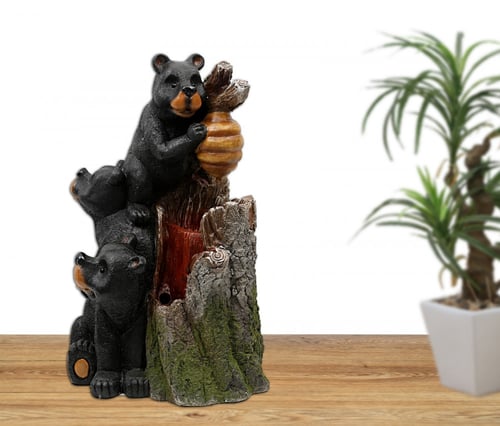 نافورة مياه مضيئة علي شكل جذع شجرة و مزين بالدب مق...