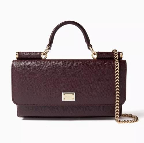 A small bag with a necklace and a box in maroon color