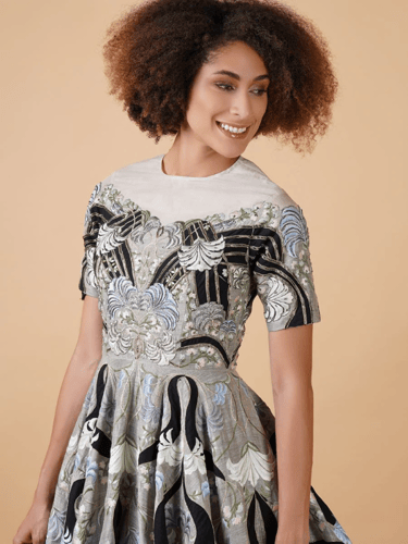 Featured here is a high-neck fit, A-line floor len...