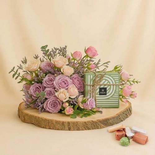 A bouquet of purple roses with chocolates