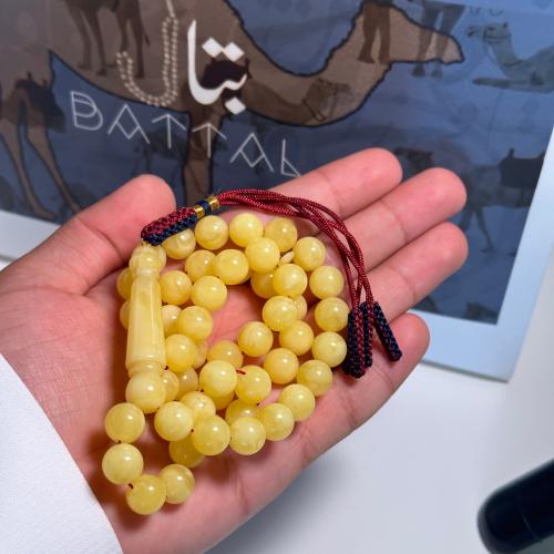 Amber-colored clay prayer bead string