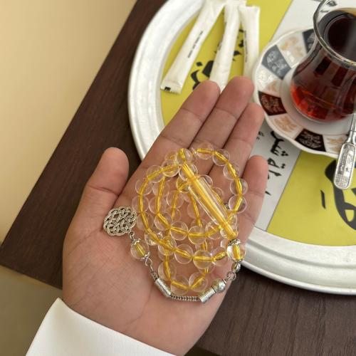 A prayer bead with a clear yellow color