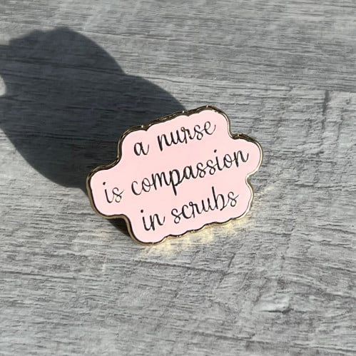 دبوس A nurse is compassion in scrubs