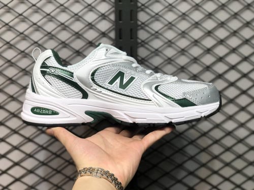 New Balance 530 trainers in white & green