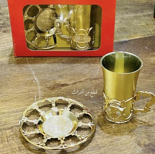 Among the rare items; a cardboard box inside it a metal plate with beautiful engravings and a plastic tea cup; an old museum piece...