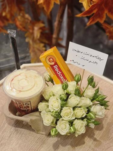 A bouquet of roses with two gallons of luxurious j...