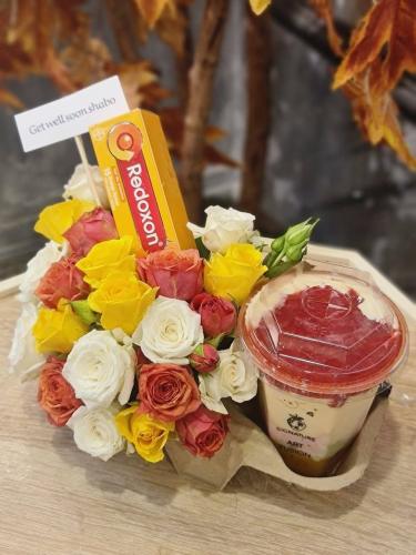 A bouquet of roses with two gallons of luxurious j...