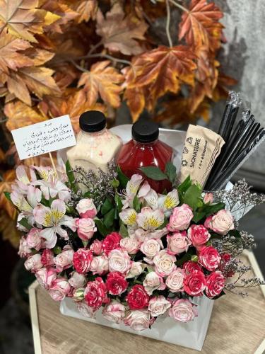 A bouquet of pink roses and Max and Stomaria with...