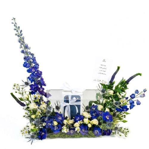 Luxurious natural flower arrangement with blue del...