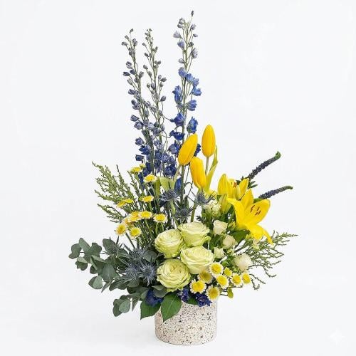 A natural flower vase with a bright arrangement an...
