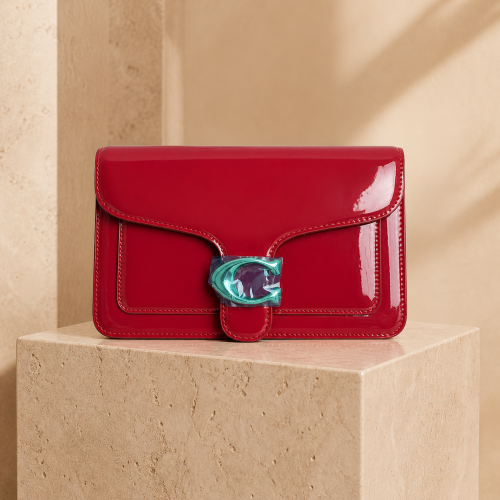 The shiny coach bag in the color of crimson red