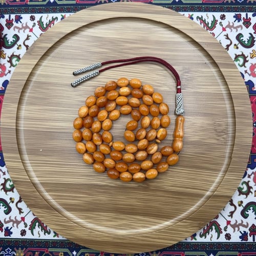 سبحة مسكي عسلي برتقالي – 65 خرزة – قصة بيضاوية – ش...