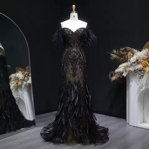 Elegant evening dress with a mermaid design, decorated with beads, feathers, and crystals