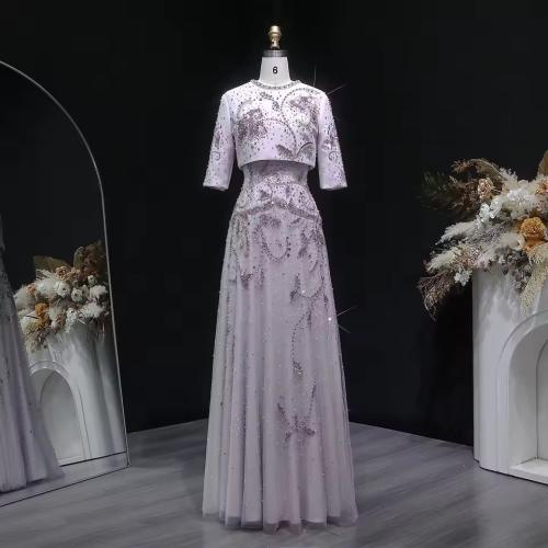Elegant evening dress consisting of two pieces with half sleeves embroidered with pearls and embroidery