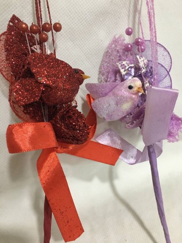 A rosebud with a bird figurine