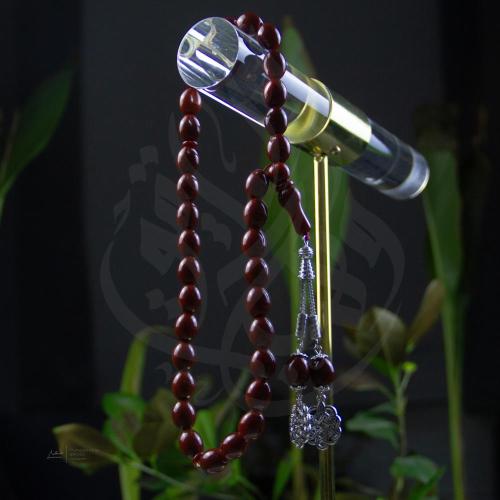 سبحة بلون أسود طربزونة وخرز بيضاوي شبه شفاف