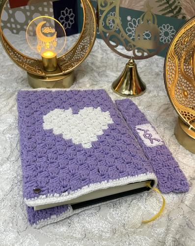 Quran cover with a heart design and a tassel with...