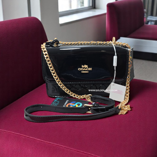 حقيبة كوتش لماع أسود تابي