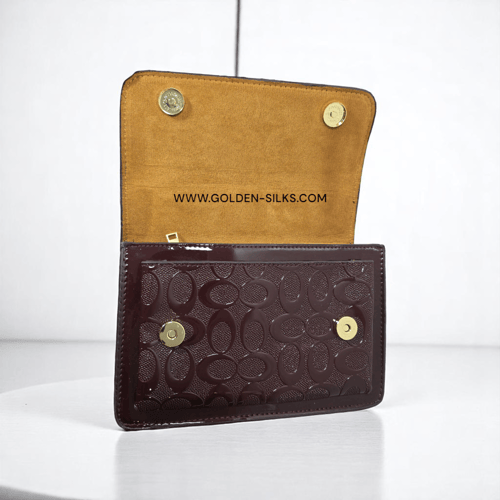 حقيبة كوتش لماع عنابي تابي