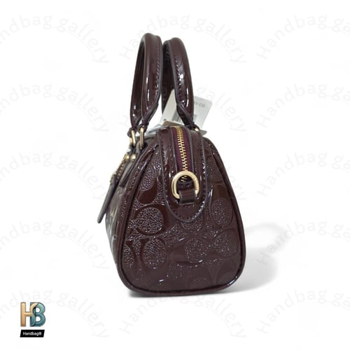 حقيبة كوتش روان عنابي ميني لماع