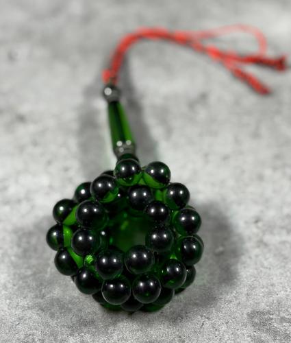 A bracelet with a transparent green quartz bead