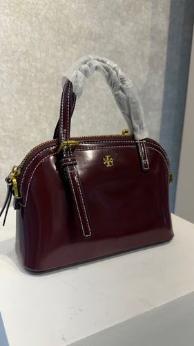 A luxurious maroon bag from Tory Burch