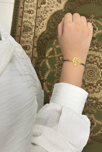 A string bracelet plated with gold or silver