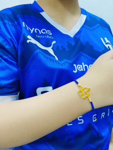 A string bracelet plated with gold or silver
